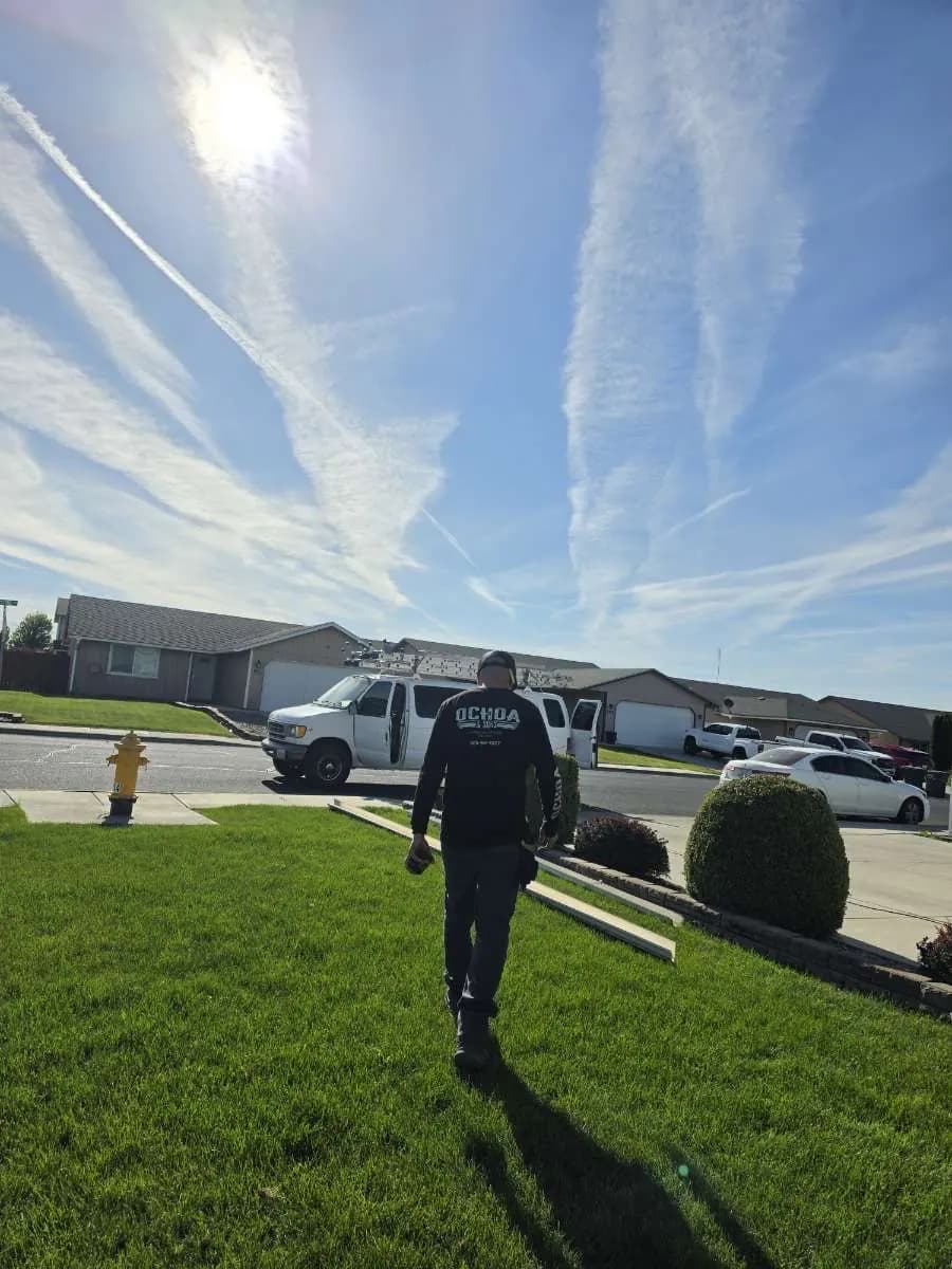 Crew member carrying a finished gutter run to the house