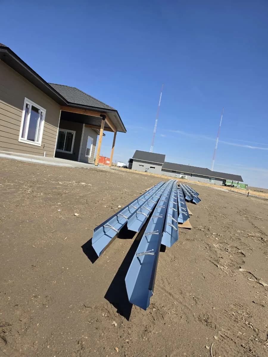 Gutter sections staged at a home during an estimate
